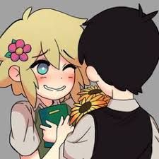 a boy and girl hugging each other with flowers in their hair