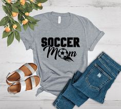 "Welcome to PacificDreamStudios! 🌴 https://www.etsy.com/shop/pacificdreamstudios PERSONALIZED \"Soccer Mom\" T-SHIRT A custom \"Soccer Mom\" design printed on this cotton/poly blend shirt. The super soft and comfortable fabric makes this the perfect shirt for going out or just plain lounging. Oh and did we mention, this could be the perfect gift for that special someone in your life? Check out the rest of our store for more tees! 📌 STYLE AND FIT These t-shirts are made of cotton/poly blend. Su Soccer Dad Shirt, Soccer Love, Sporty Mom, Soccer Moms, Soccer Svg, Sports Mom Shirts, Soccer Tees, Soccer Mom Shirt, Hockey Shirts