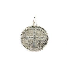 Size: About 3/4 inch diameter (2cm) Item number: whmsc143 This is a traditional St. Benedict amulet or medal with an image of St. Benedict on the front and a cross on the back. Both front and back are inscribed with symbols and various text in ecclesiastical Latin, one of which translates to 'Begone, Satan'. The St. Benedict medal is basically a Christian object believed to protect from curses, evil, and diseases and bring good health. Commemorative Coin Pendant, Spiritual Round Pendant Locket, Engraved Coin-shaped Spiritual Jewelry And Charms, Round Coin Pendant For Commemoration, Symbolic Engraved Crucifix Jewelry, Engraved Spiritual Medallion Jewelry, Engraved Cross Pendant For Commemoration, Engraved Round Pendant For Commemoration, St Benedict Medal