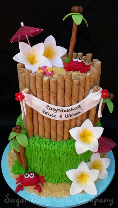 a cake made to look like a bamboo fence with flowers and umbrellas on top