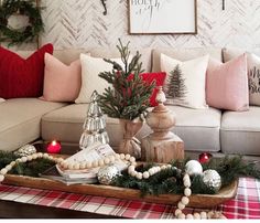 a living room with christmas decorations on the coffee table