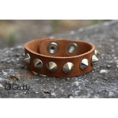 Handcrafted leather bracelet with one row of short metal spikes. You can adjust the length, as it comes with two different buttons. Width 18mm. Length 23cm. Minimum wrist measurement 19cm. We suggest you measure your wrist and give us the measurement before shipping. Trendy Adjustable Spiked Bracelets, Adjustable Brown Punk Bracelets, Silver Leather Bracelet With Spikes, Silver Leather Bracelets With Spikes, Punk Style Brown Leather Jewelry, Brown Leather Punk Style Jewelry, Edgy Adjustable Bracelets With Studs, Trendy Adjustable Bracelets With Rivets, Adjustable Cuff Bracelet With Rivets