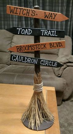 a wooden sign sitting on top of a table in front of a couch and chair