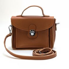 The Isabelle is an elegant and versatile satchel bag designed to complement your everyday style. Materials: Handcrafted from durable, high-quality leather. Functional Interior: Offers a well-organized interior with enough space for your essentials, including a phone, wallet, keys, and small personal items. The secure flap with a lock closure ensures your belongings are safe and easily accessible. Versatile Carrying Options: The adjustable shoulder strap allows for comfortable cross-body wear, wh Functional Interior, Contents Design, Chic Accessories, Satchel Bag, Phone Wallet, Everyday Style, High Quality Leather, Satchel Bags, Classic Looks