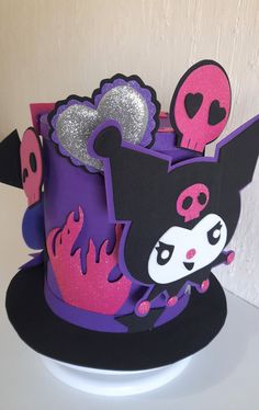 a purple and black cake with skulls on it