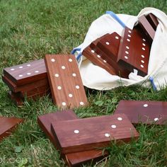 several pieces of wood sit on the ground in front of a white bag with polka dots