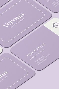 four business cards with the name and number of each card in white on purple background