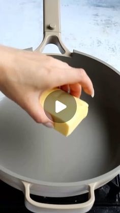 someone using a sponge to clean a wok