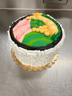 a decorated cake sitting on top of a metal counter