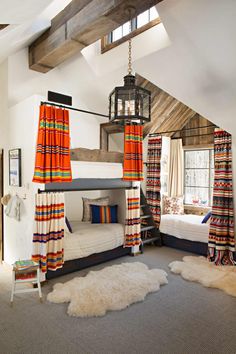 a bedroom with bunk beds, curtains and rugs on the floor in front of windows