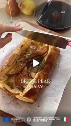 a person holding a knife over a piece of food on top of a white paper