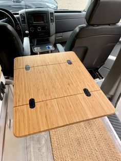 the interior of a vehicle with a table and seats in it's center console