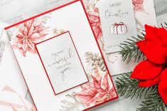 two christmas cards with poinsettis on them next to a bouquet of flowers