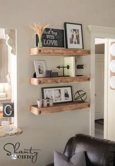 three wooden shelves on the wall above a black leather chair in a room with white walls