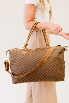 Did someone say must-have bag? The Olivia weekender is an absolute essential in every woman's closet. the timeless patterns, buttery smooth vegan leather, and versatile straps make it a top contender for the title of the perfect travel bag. Details: 26" long x 15" height x 7" wide Detachable strap adjusts to 42" long Gold hardware 3 interior pockets, including 1 with a zipper Trendy Beige Travel Bag, Brown Travel Bag With Adjustable Strap For Everyday, Brown Travel Luggage With Adjustable Strap, Trendy Beige Weekender Bag For Travel, Brown Luggage With Adjustable Strap, Brown Luggage With Adjustable Strap For Everyday Use, Travel Weekender Tote With Adjustable Handle, Travel Weekender Bag With Adjustable Handle, On-the-go Travel Bag With Adjustable Strap