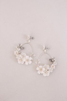 the white flower hoop earrings are on display