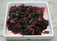 a white bowl filled with lots of red food