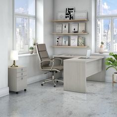 an office with a desk and chair in front of two large windows overlooking the city