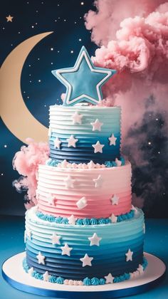 a three tiered cake with stars and clouds in the background on a blue surface