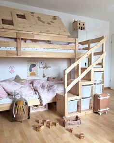 there is a bunk bed with stairs in the room and toys on the floor next to it