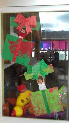 there is a child's handmade christmas decoration in the window