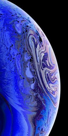 the back side of an iphone with blue and purple swirls on it, against a black background