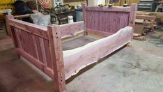 a bed frame made out of wood in a workshop