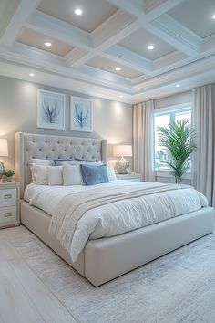 a large white bed sitting in a bedroom next to two lamps on either side of the bed