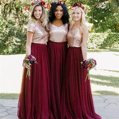 three bridesmaid in burgundy dresses with gold sequins and flowers on their head