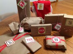 several wrapped presents sitting on top of a wooden table