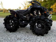 a black four - wheeled vehicle parked on gravel