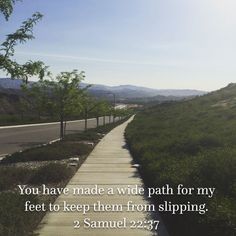 a path leading to the top of a hill with a bible verse