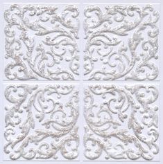 four square white tiles with ornate designs on them