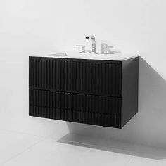 a black and white photo of a sink cabinet with two faucets on it