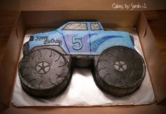 a birthday cake in the shape of a monster truck