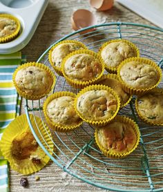 several muffins on a wire rack next to eggs