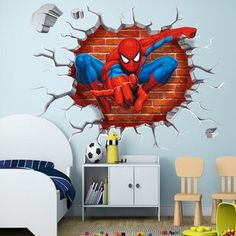 a spiderman wall sticker on the side of a brick wall in a child's room