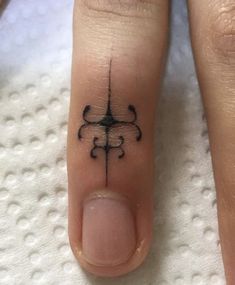 a person with a small tattoo on their thumb and toe is shown in black ink