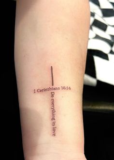 a woman's arm with a cross on it and the words, i corintian