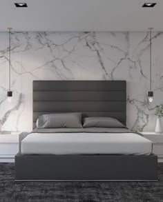 a modern bedroom with marble walls and flooring, along with a large bed in the center