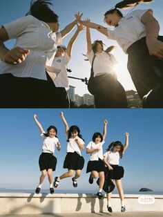 four girls are jumping in the air with their hands up and one girl is holding her arms out