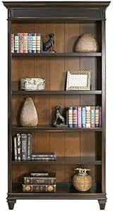 a book shelf with many books and other items on it's shelves in a room