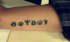 a person with a tattoo on their arm that says, i love you and paw prints