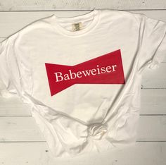 This is the perfect beer shirt for women for parties, casual get-togethers, or those days where you chill with a Budweiser all on your own! Buds are out, babes are in! Buds are out, babes are in! This is the perfect shirt for parties, casual get-togethers, or those days where you chill with a Budweiser all on your own! About the T-Shirt: Pictured is a white comfort colors shirt with red vinyl -The design was printed with vinyl and done with a heat press -6.1 oz., 100% ring spun cotton -Men's/uni Beer T Shirt Design, Shirt Outfit Summer, Country Thunder, Country Festival, Womens Graphic Tees, Alpha Gam, Diy Shirts, Outfits Dressy, Red Vinyl