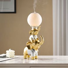 an elephant lamp sitting on top of a table