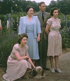 four people and a dog posing for a photo