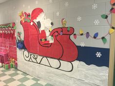 a decorated wall with santa clause riding a sleigh and presents on the side