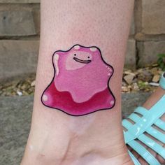 a person with a tattoo on their foot that has a pink and red jelly in it