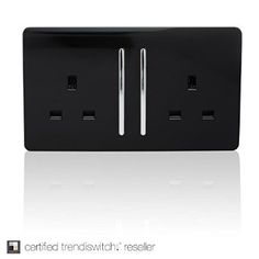 a black electrical outlet cover with two white outlets on each side and one light switch in the middle