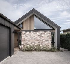 a brick house with two garage doors and windows